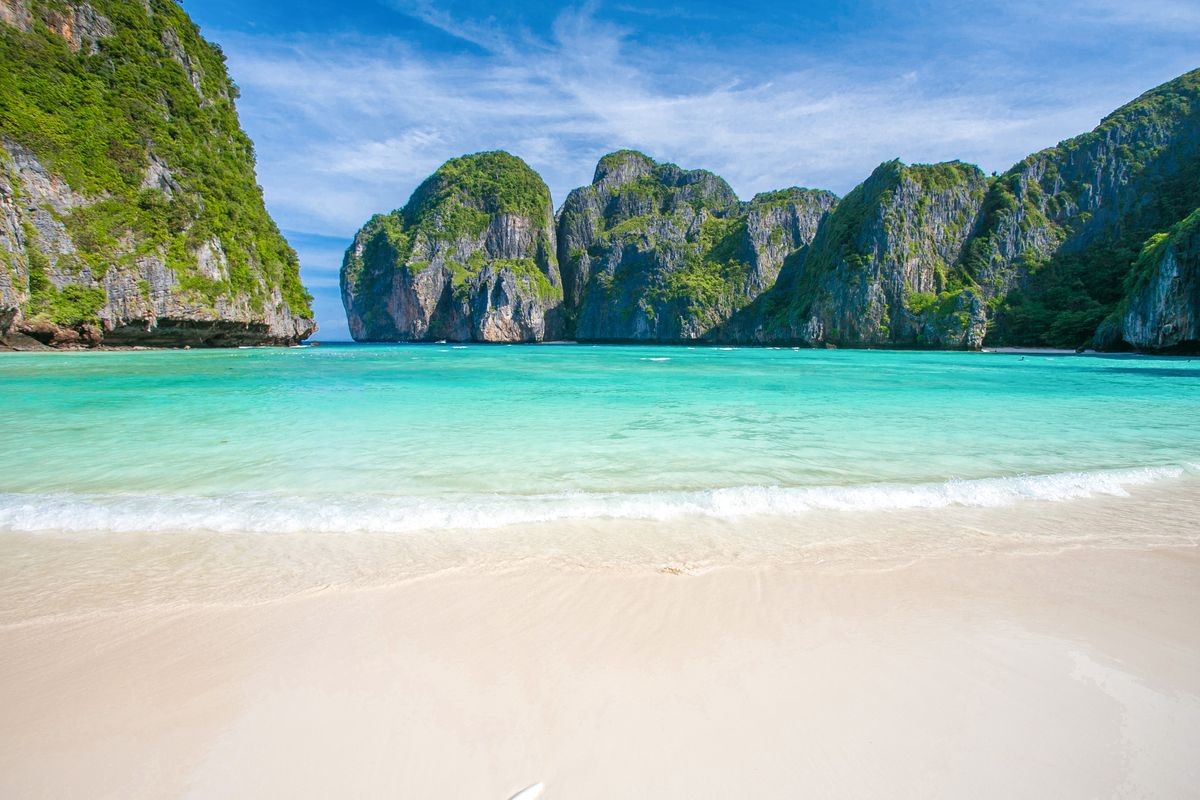 Travel vacation and holiday background, Summer beach, of Maya Bay, Phi Phi Island, with white sand beach, overlooking clear water, and beautiful sky, Maya Bay, Phi Phi Island, Phuket, Thailand.