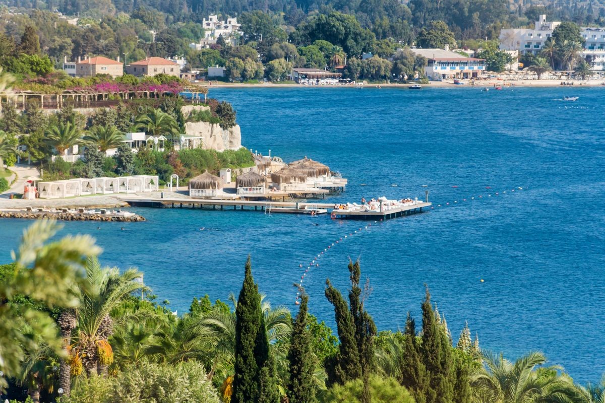 Beautiful Beach with Green Palms and Blue Sea  in Bodrum, Turkey. Luxury Resort, Travel and Vacation Concept